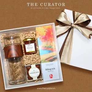 Relax Tea gift box conveys complete peaceful wishes through premium tea set with elegant infuser plus pure honey and coffee-covered chocolate, creating sophisticated gift featuring authentic Vietnamese specialties perfect for corporate gifting.