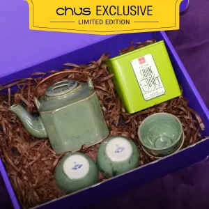 Tea set with Ancient Snow Shan Tea gift box showcasing premium Bat Trang ceramics and traditional tasting artistry, presented as an exclusive Vietnamese cultural souvenir with personalized card.