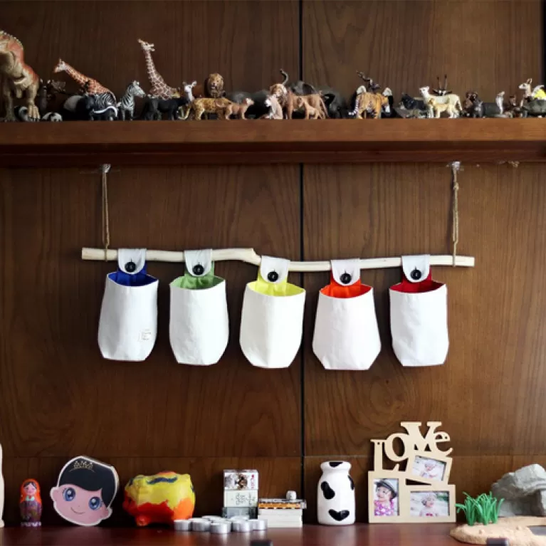 cloth hang wall organizer, neatly stores items, unique design, made from cotton canvas, sturdy and durable, home decor