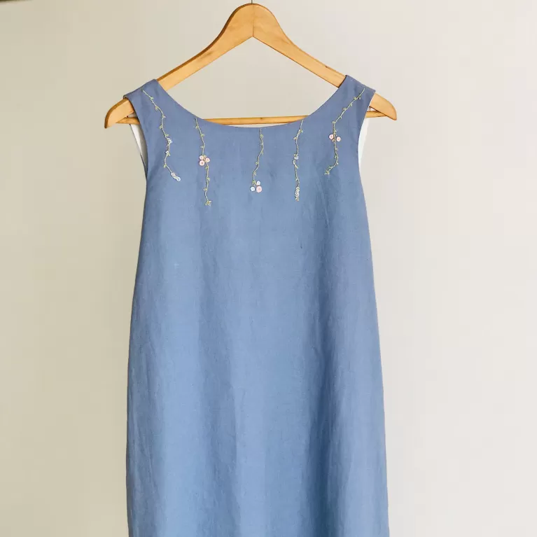 linen bow dress with floral embroidery, soft two-layered fabric, handcrafted embroidery patterns, exquisitely sewn lines