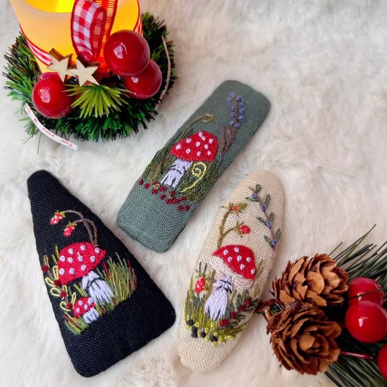 hand embroidery mushroom hair clip, inspired by amanita muscaria mushroom, mysterious and attractive style, vintage fairy style