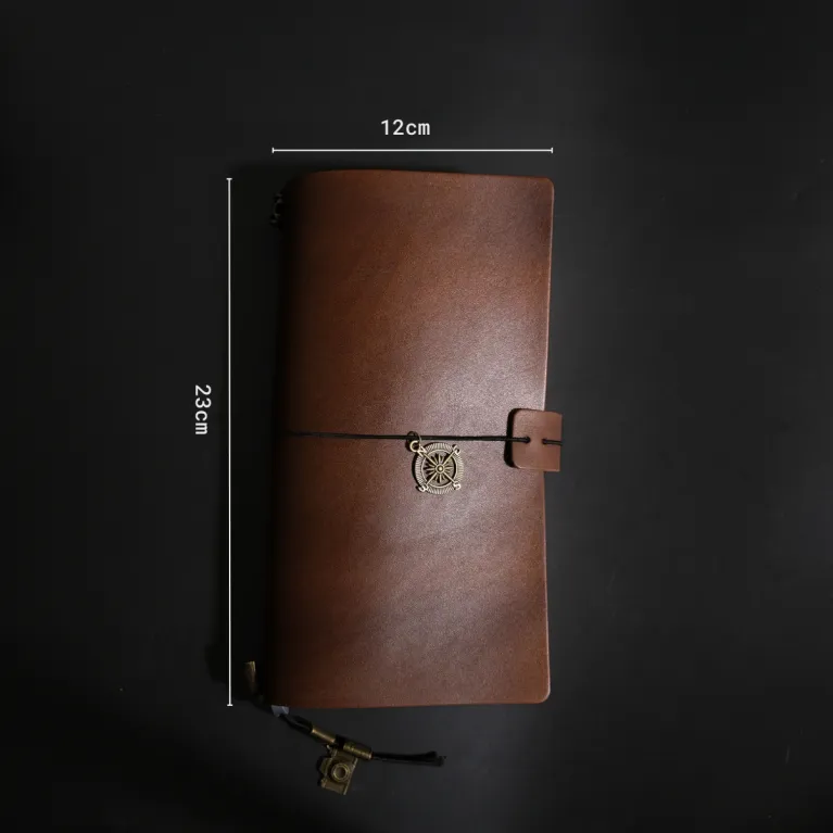 The Veg Tan Journal (23x12cm) is a genuine leather notebook with a classic and elegant style, featuring hand-dyed leather and decorative charms, making it a unique corporate gift for any occasion