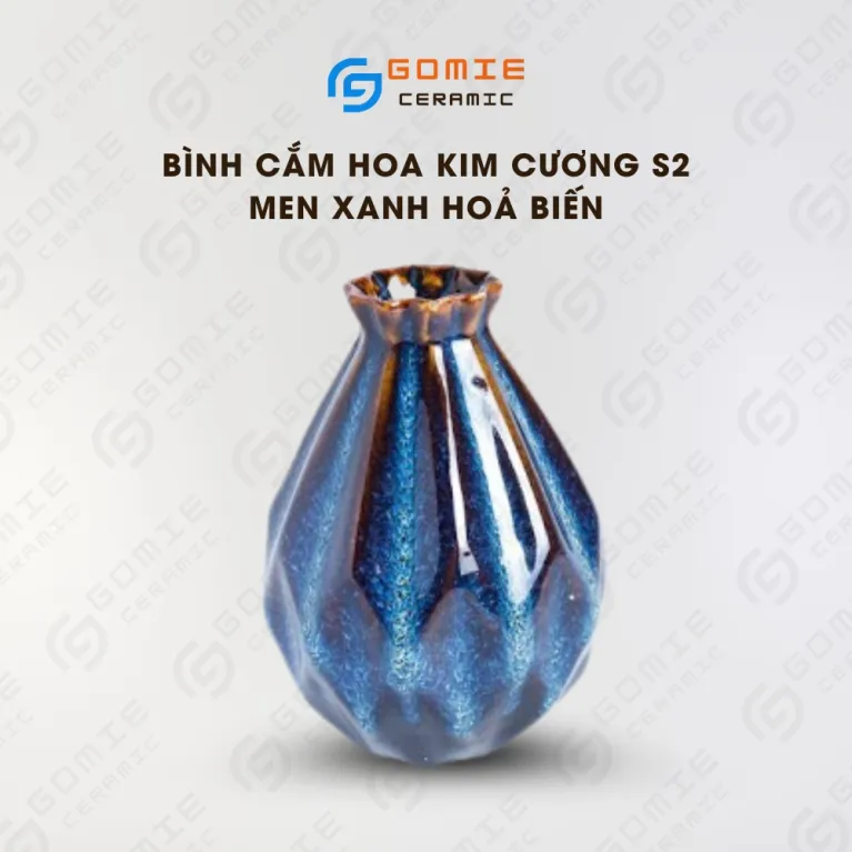The Ocean Blue Fire-Glazed Diamond Ceramic Vase from Bat Trang Ceramic is an exquisite pottery vase that serves as a stunning stage for floral beauty, making it a perfect home decor piece and an ideal housewarming gifts