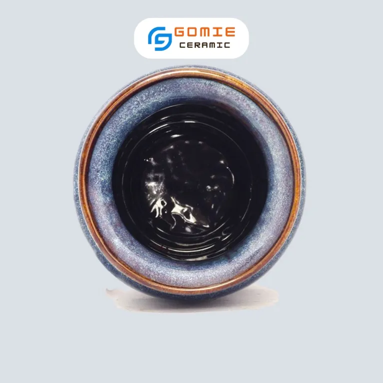 The Ocean Blue Fire-Glazed Tall Flared Ceramic Vase from Bat Trang Ceramics combines timeless and enchanting style, making it a perfect pottery vase for home decoration and an ideal housewarming gift.