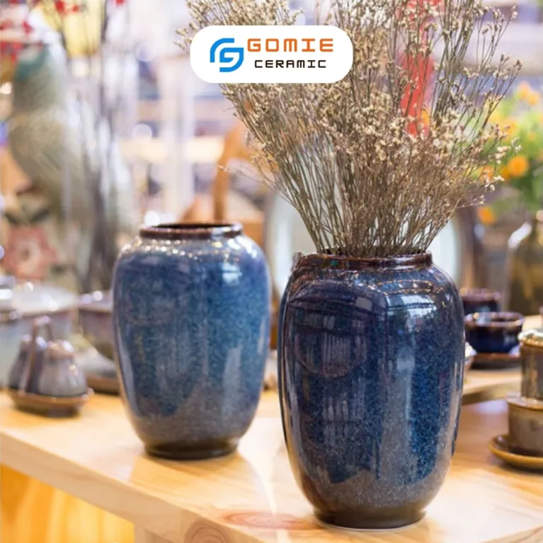 The Ocean Blue Fire-Glazed Ceramic Tube Vase from Bat Trang Ceramics is a minimalistic yet memorable cylinder pottery vase, perfect for home decoration or as a thoughtful housewarming gift.The Ocean Blue Fire-Glazed Ceramic Tube Vase from Bat Trang Ceramics is a minimalistic yet memorable cylinder pottery vase, perfect for home decoration or as a thoughtful housewarming gift.