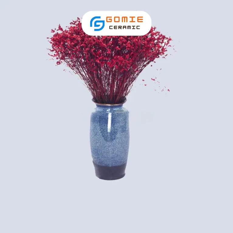 The Ocean Blue Fire-Glazed Tall Flared Ceramic Vase from Bat Trang Ceramics combines timeless and enchanting style, making it a perfect pottery vase for home decoration and an ideal housewarming gift.