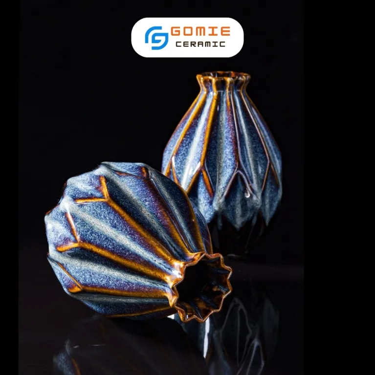 The Ocean Blue Fire-Glazed Diamond Ceramic Vase from Bat Trang Ceramic is an exquisite pottery vase that serves as a stunning stage for floral beauty, making it a perfect home decor piece and an ideal housewarming gifts