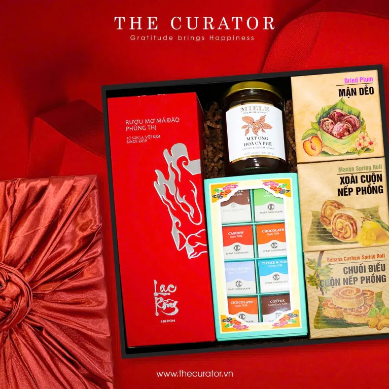 "The Festive Season" Gift Box, features a curated selection of Vietnamese Delicacies, including Phung Thi Apricot Craft Liqueur, Coffee Blossom Honey, and Chocolate and Fruit.