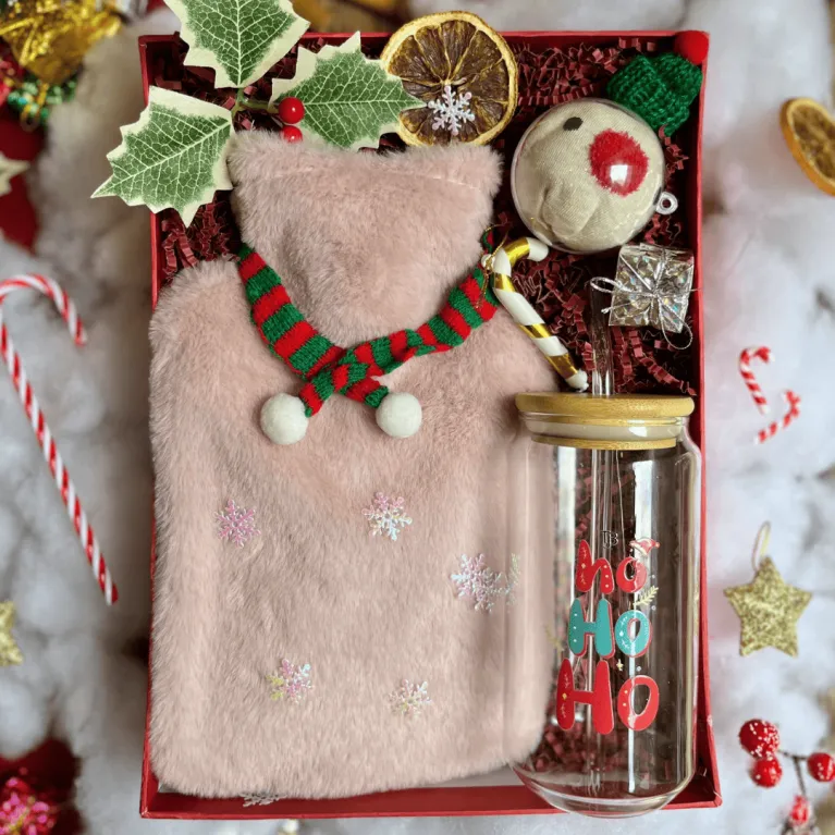 The "A Warm Embrace" Christmas Gift Set, as warm as a hug, includes a heating pad, festive glass cup, and cozy Christmas socks, making it the perfect gift for her or a thoughtful corporate gift this holiday season