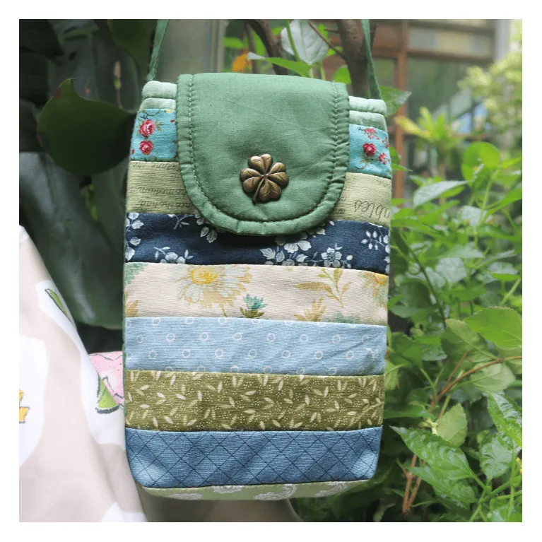 The Magpie Robin Phone Bag, with its vibrant and vintage colors, is a charming handmade patchwork phone pouch, doubling as a mini crossbody bag and making it a perfect vintage handmade accessory and thoughtful gift for her