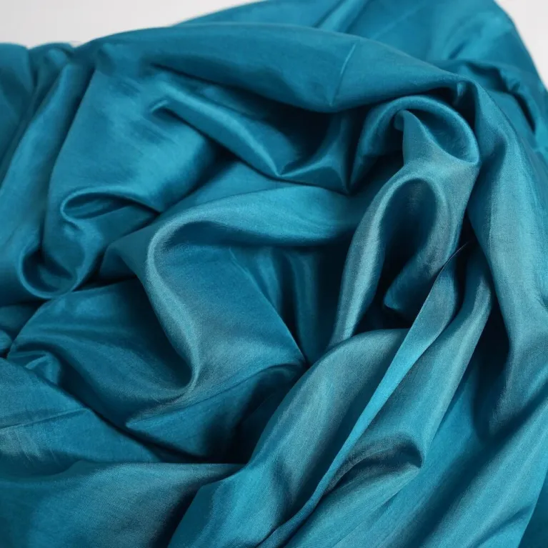Deep Teal Silk Scarf, handwoven from natural silk, offers a deep tone for a refined look - an elegant fashion accessory and luxury gift for her, making it an impressive Vietnamese gift.