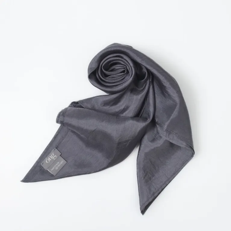 This Grey Silk Square Scarf, a traditionally woven and handcrafted Vietnamese accessory made from natural silk, offers a subtle yet luxurious look, making it a thoughtful gift for her
