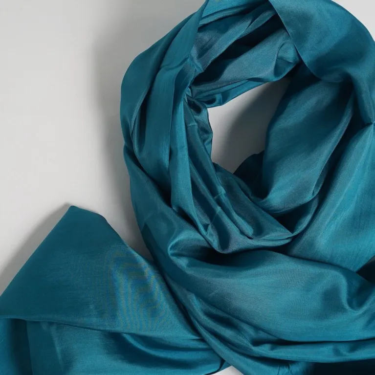 Deep Teal Silk Scarf, handwoven from natural silk, offers a deep tone for a refined look - an elegant fashion accessory and luxury gift for her, making it an impressive Vietnamese gift.