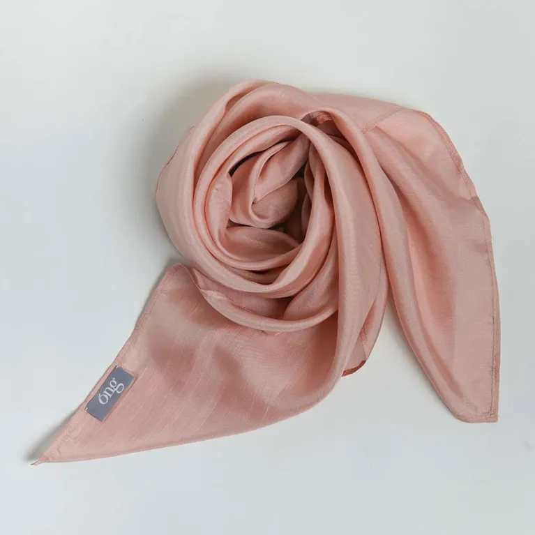 The Rose Pink Silk Scarf, handcrafted from natural silk, beautifully enhances her youthful glow, making it a timeless feminine accessory that blends tradition with elegance - an exquisite Vietnamese gift perfect for her