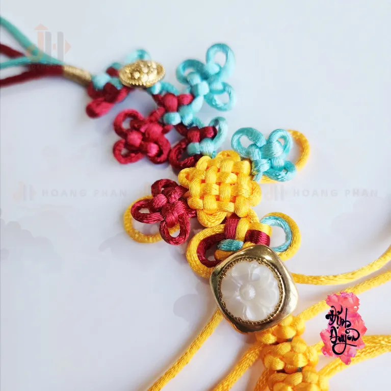 The "Nhu Y" Knot Moon Hanging Decoration is a beautiful traditional ornament that serves as a positive energy source, making it a perfect Feng Shui gift and decorative accessory for any space - an elegant and meaningful gift for her.