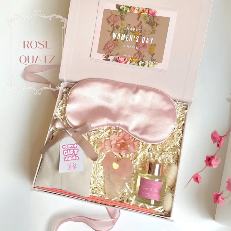 The "Rose Quartz" Gift Box is a romantic Women's Day gift designed to cherish your beloved woman, featuring a luxurious Gua Sha stone, soothing eye mask, essential oil, and a surprise blind bag for an extra touch of love and elegance