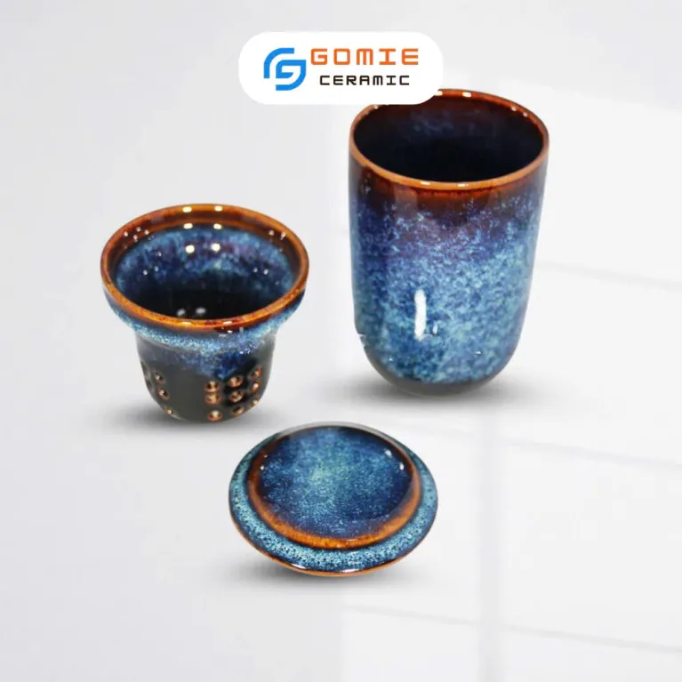 Enhance your tea ritual with the Blue Fire-Glazed Ceramic Tea Infuser Mug, a beautifully crafted Bat Trang ceramic piece that blends elegance and function - perfect as a ceramic souvenir, decoration, or a refined tea infuser pot for a more exquisite tea time experience.
