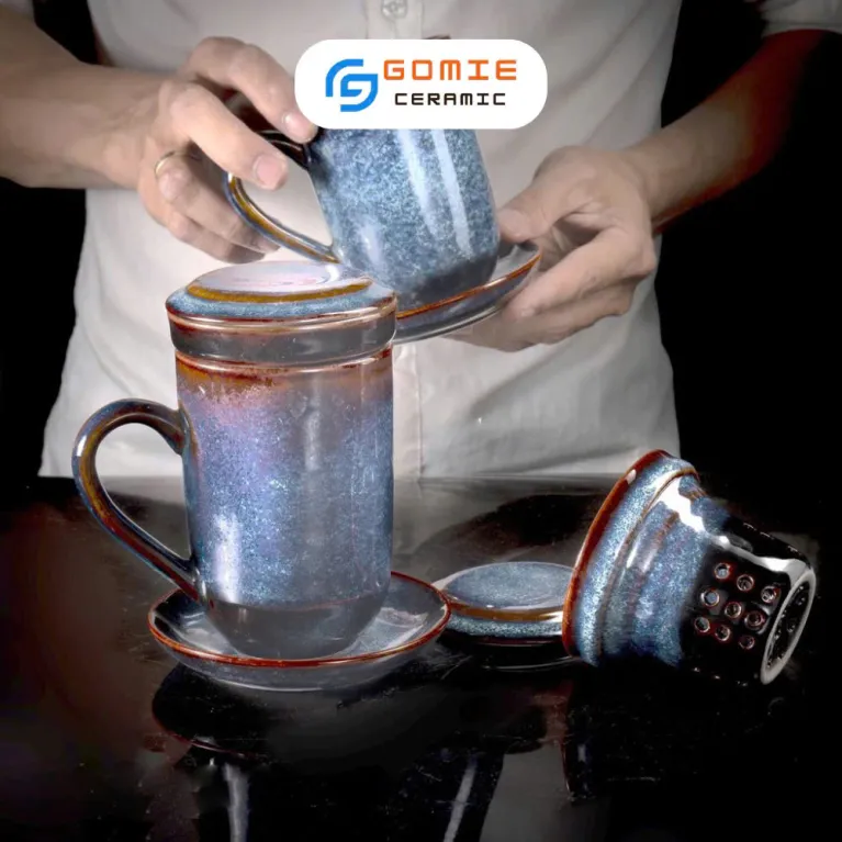 Enhance your tea ritual with the Blue Fire-Glazed Ceramic Tea Infuser Mug, a beautifully crafted Bat Trang ceramic piece that blends elegance and function - perfect as a ceramic souvenir, decoration, or a refined tea infuser pot for a more exquisite tea time experience.