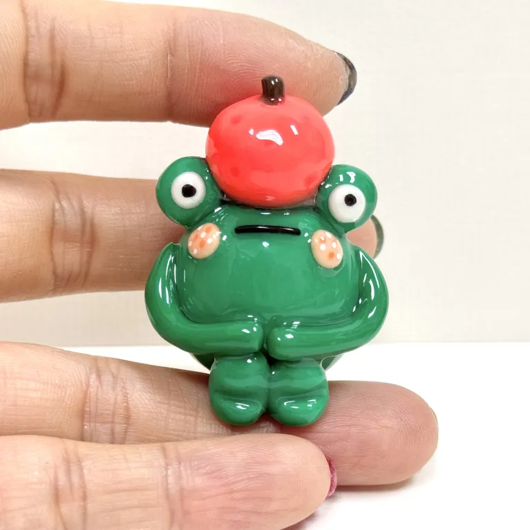 The Handmade Clay Orange-Hat Frog Figurine is a unique and humorous idea, crafted as an adorable decorative accessory and a cute clay toy, making it a charming and one-of-a-kind gift for her.