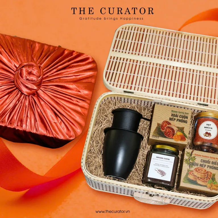 Discover the "Vietnam Flavor Treasure" Gift Set, a premium taste of Vietnam with specialty treats, a ceramic mug, and a traditional coffee filter