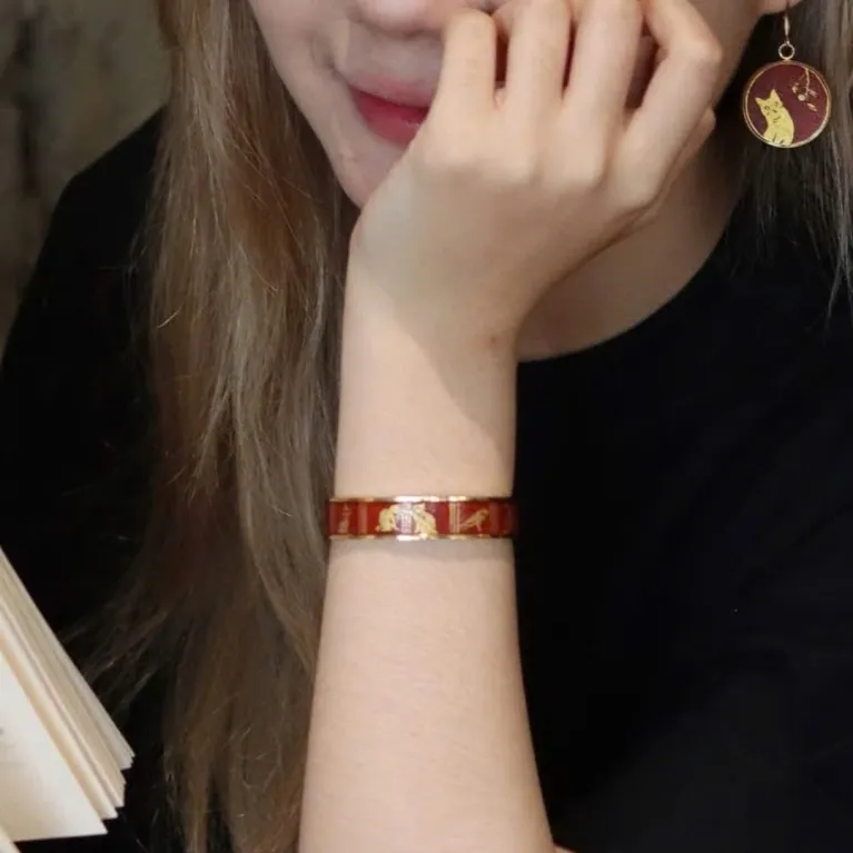 The "Cat & Box" Metal Cuff Bracelet With Hand-Painted Leather is a handmade fashion accessory that beautifully highlights individuality, making it a perfect birthday gift for her.
