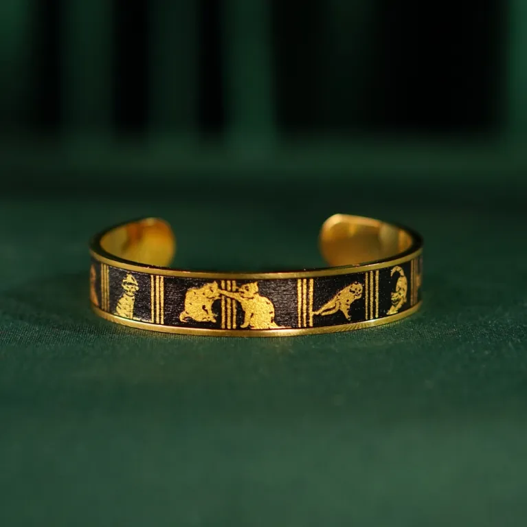 The "Cat & Box" Metal Cuff Bracelet With Hand-Painted Leather is a handmade fashion accessory that beautifully highlights individuality, making it a perfect birthday gift for her.
