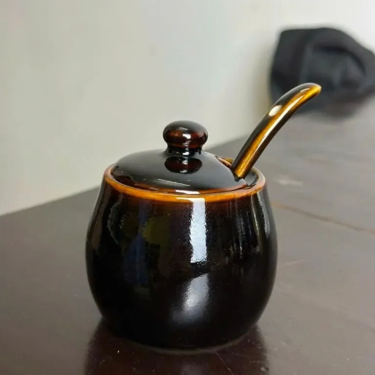 The Fire-Glazed Ceramic Spice Jar is a masterpiece of Bat Trang craftsmanship, exquisite down to every detail, making it a perfect addition to your kitchen accessories collection. Crafted from Vietnamese ceramics, this jar is not just a functional piece but also a unique souvenir that adds elegance to any space