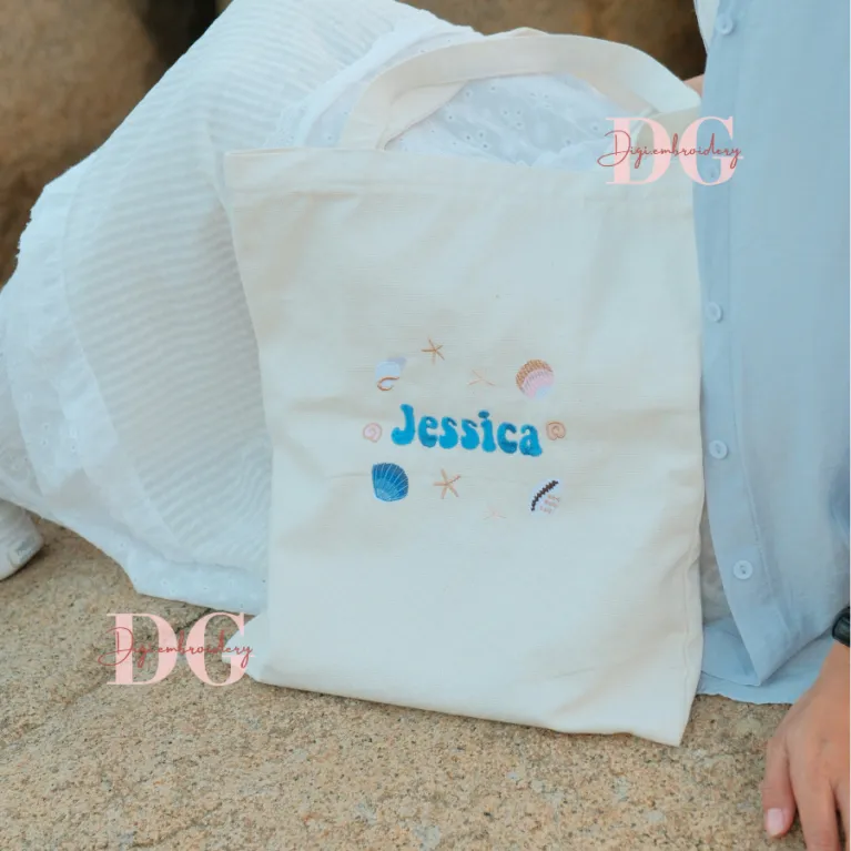 The Personalized Embroidered Name Tote Bag is a distinctive accessory, crafted from durable canvas with a convenient zippered design, making it the perfect personalized gift and a unique birthday gift for any occasion.