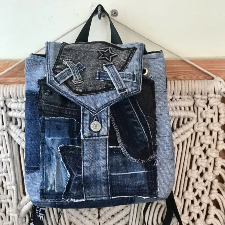Diagonal pattern mini backpack repurposed from old jeans features bold linear elements, combining denim style with durable fabric construction as sustainable fashion accessory and uniquely creative handcrafted birthday gift