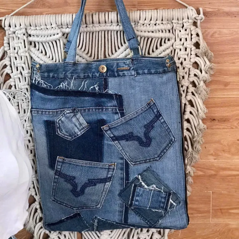 Slim bottom tote crafted from old jeans creates an exclusively yours accessory, combining upcycled materials with fashion-forward design as sustainable fashion statement and meaningful eco-friendly handmade gift