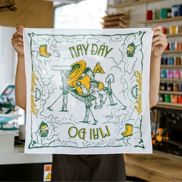 Here Today - Gone Tomorrow scarf serves as a statement piece for travel enthusiasts, featuring artistic designs printed on exclusive cotton fabric, doubling as both a practical travel accessory and authentic Vietnamese souvenir.