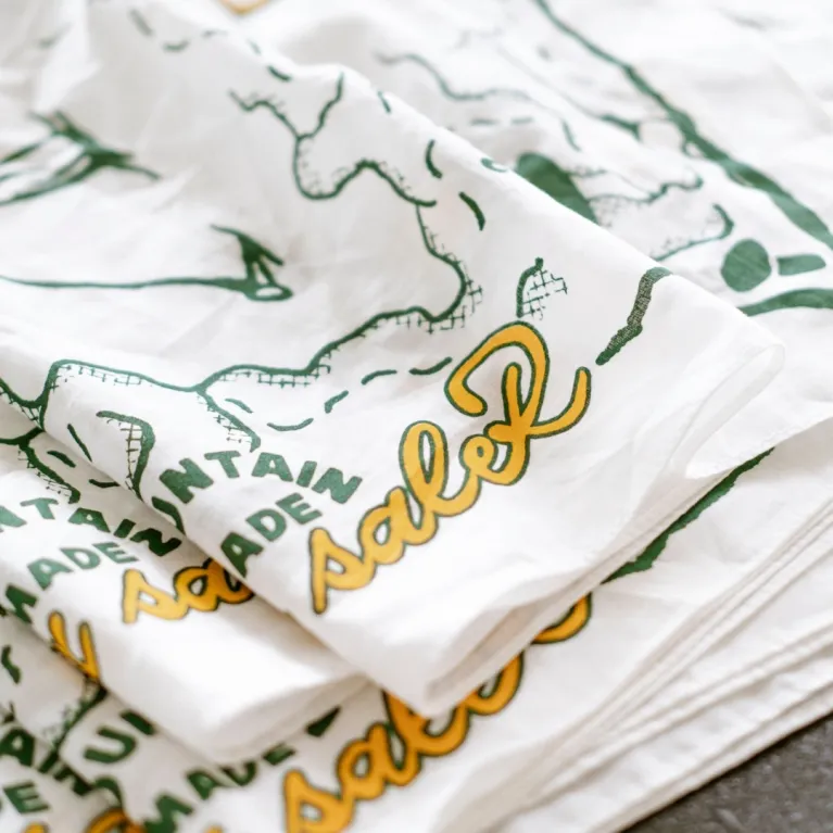 Here Today - Gone Tomorrow scarf serves as a statement piece for travel enthusiasts, featuring artistic designs printed on exclusive cotton fabric, doubling as both a practical travel accessory and authentic Vietnamese souvenir.