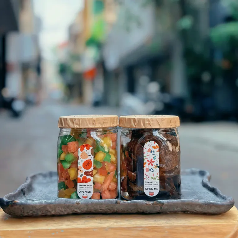 Candied pomelo pith and honey kumquat gift box delivers rich authentic flavors in traditional checkered scarf-wrapped packaging, offering Vietnamese specialty treats as healthy snacks and wellness gifts