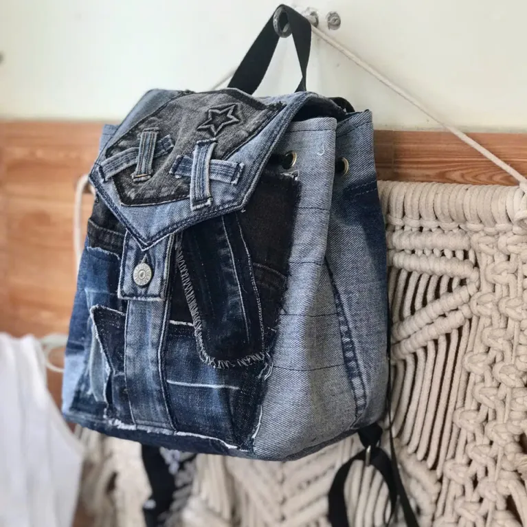 Diagonal pattern mini backpack repurposed from old jeans features bold linear elements, combining denim style with durable fabric construction as sustainable fashion accessory and uniquely creative handcrafted birthday gift