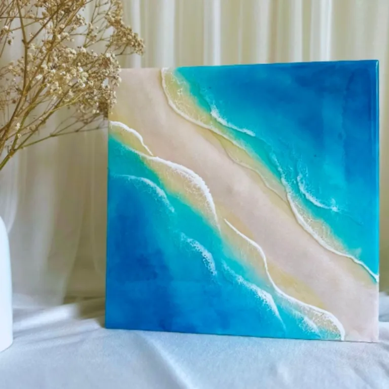 Smooth epoxy resin art measuring 30 x 30cm captures gentle ocean beauty through 3D epoxy resin seascape techniques, creating handcrafted wall art perfect as meaningful housewarming gift.