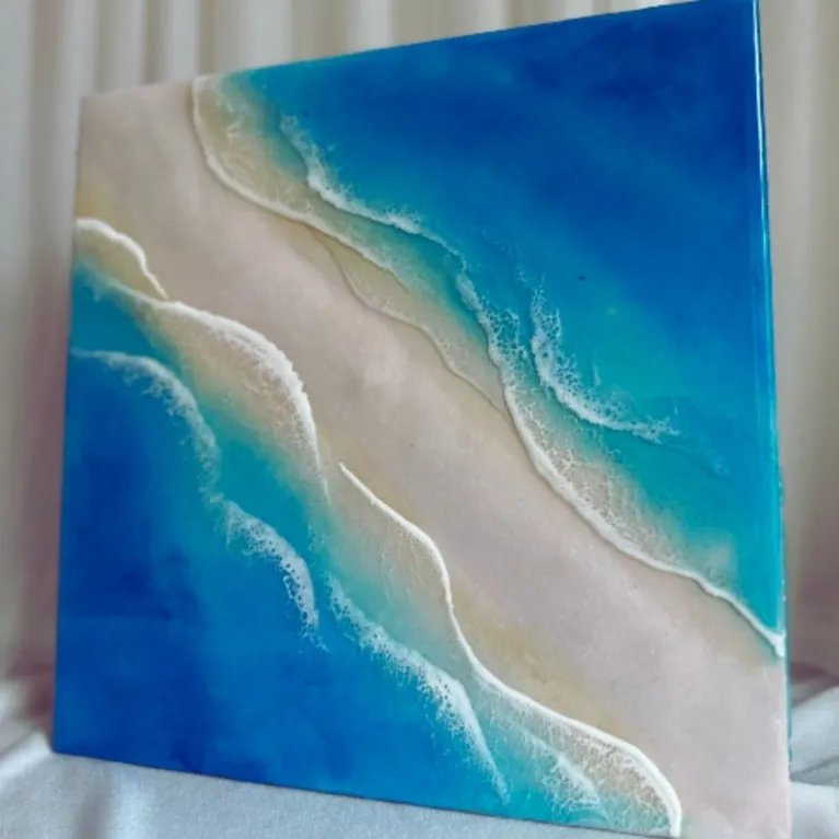 Smooth epoxy resin art measuring 30 x 30cm captures gentle ocean beauty through 3D epoxy resin seascape techniques, creating handcrafted wall art perfect as meaningful housewarming gift.