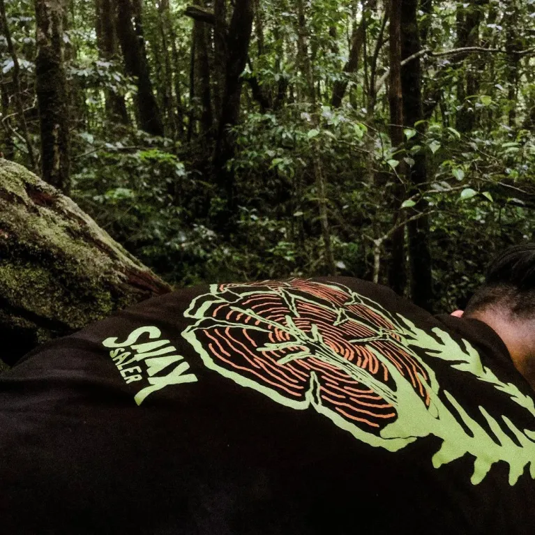The "Here To Hear" cotton T-shirt connects nature and time with a creative design and comfortable fabric, perfect for travel, adventures, or as a birthday gift.