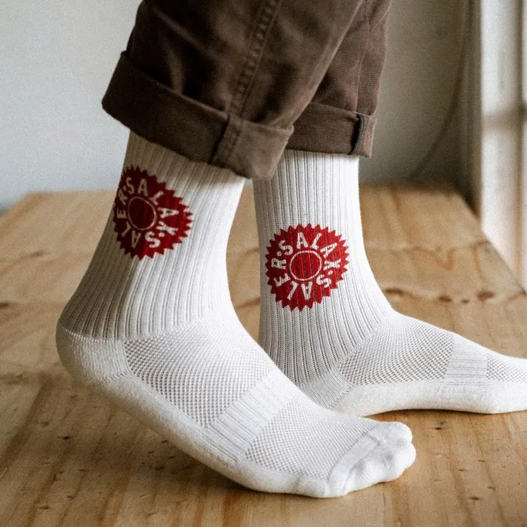 White cotton crew socks with Salaxsaler’s exclusive signature, crafted from soft thick cotton and hand-silkscreened—perfect travel socks, stylish fashion accessory, and unique souvenir.