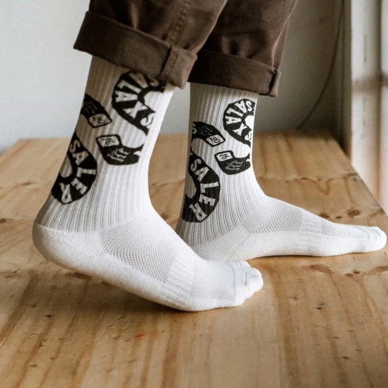 White cotton crew socks with Salaxsaler’s exclusive signature, crafted from soft thick cotton and hand-silkscreened—perfect travel socks, stylish fashion accessory, and unique souvenir.White cotton crew socks with Salaxsaler’s exclusive signature, crafted from soft thick cotton and hand-silkscreened—perfect travel socks, stylish fashion accessory, and unique souvenir.