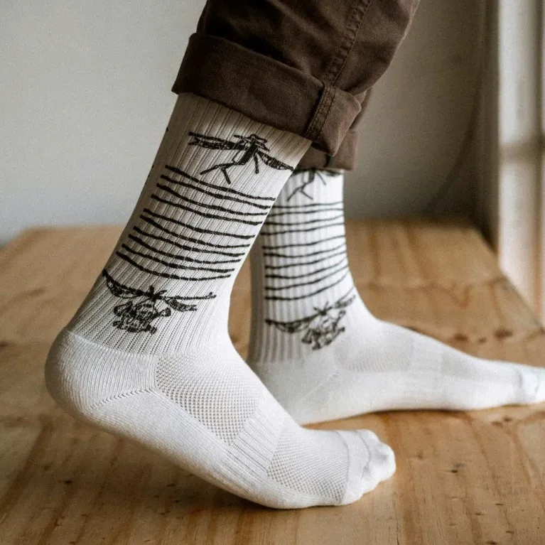 White cotton crew socks with Salaxsaler’s exclusive signature, crafted from soft thick cotton and hand-silkscreened—perfect travel socks, stylish fashion accessory, and unique souvenir.