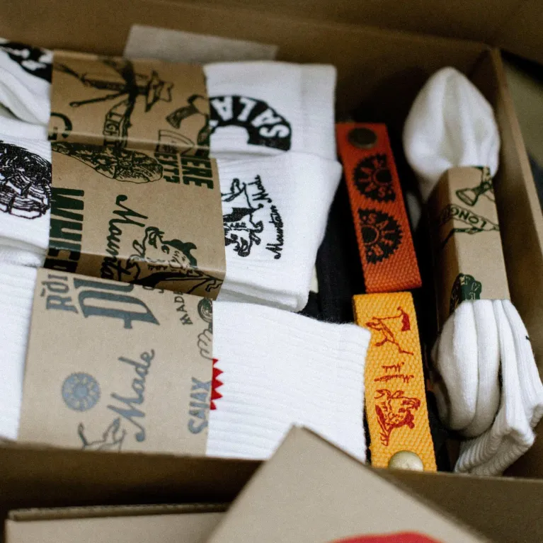 White cotton crew socks with Salaxsaler’s exclusive signature, crafted from soft thick cotton and hand-silkscreened—perfect travel socks, stylish fashion accessory, and unique souvenir.