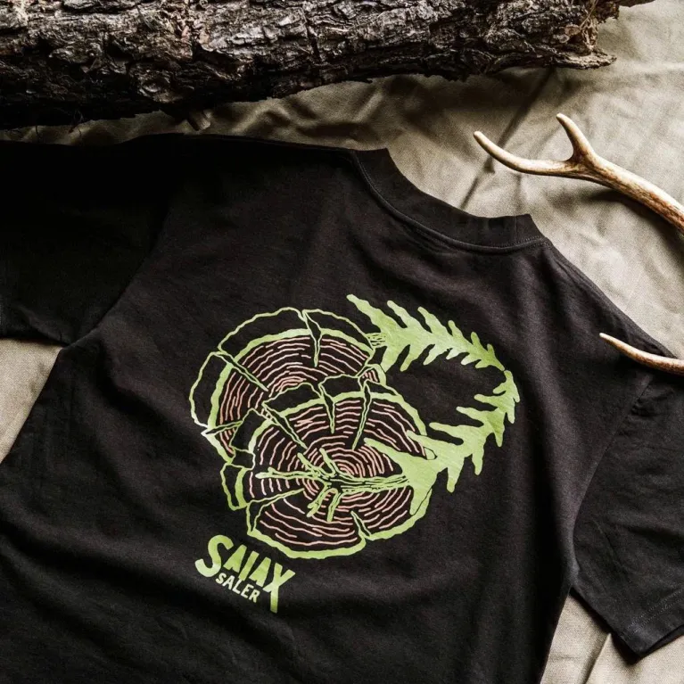 The "Here To Hear" cotton T-shirt connects nature and time with a creative design and comfortable fabric, perfect for travel, adventures, or as a birthday gift.