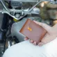 wallet with buttons, minimalist and elegant design, premium herbal leather material, luxurious style, compact size, high-quality product