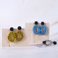 cow print abstract round shaped clay earrings, unique and eye-catching design, personalized fashion accessory, facial highlight