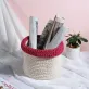 white with red and purple border crochet cotton basket, subtle contrasting colors, elegant style, adds focal point to room corner