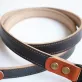 veg-tan leather camera strap, premium leather material, meticulous stitching, minimalist and practical design