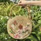 The Hasu Lepironia Grass Bag with Bamboo Handle captures the pristine beauty of lotus in a round, handcrafted water hyacinth design, making it a perfect blend of sustainable fashion and an elegant Vietnamese gift