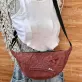 Pink half-moon crossbody bag from old jeans features one-of-a-kind color palette, creating a denim upcycled accessory and unique birthday gift for eco-conscious fashion loversPink half-moon crossbody bag from old jeans features one-of-a-kind color palette, creating a denim upcycled accessory and unique birthday gift for eco-conscious fashion lovers