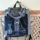 Diagonal pattern mini backpack repurposed from old jeans features bold linear elements, combining denim style with durable fabric construction as sustainable fashion accessory and uniquely creative handcrafted birthday gift