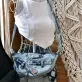 Striped blue tie-dye crossbody bag from recycled jeans – unique fabric mix creates strong impression, eco-friendly half-moon bag, sustainable fashion accessory and creative birthday gift.
